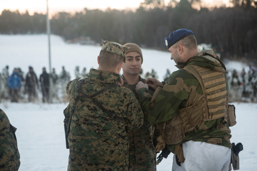 Norwegian Commander Pins U.S. Marine To The Rank Of Sergeant