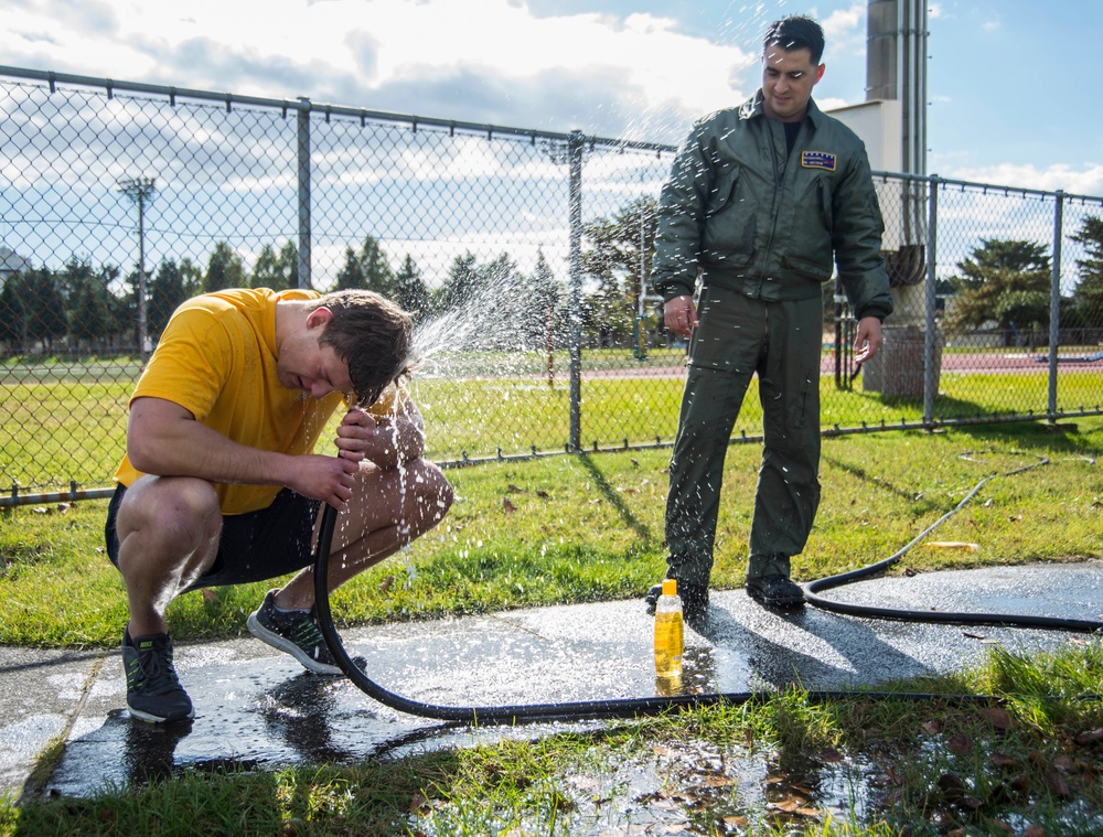 Sailor washes off oleoresin capsicum spray after a training exercise