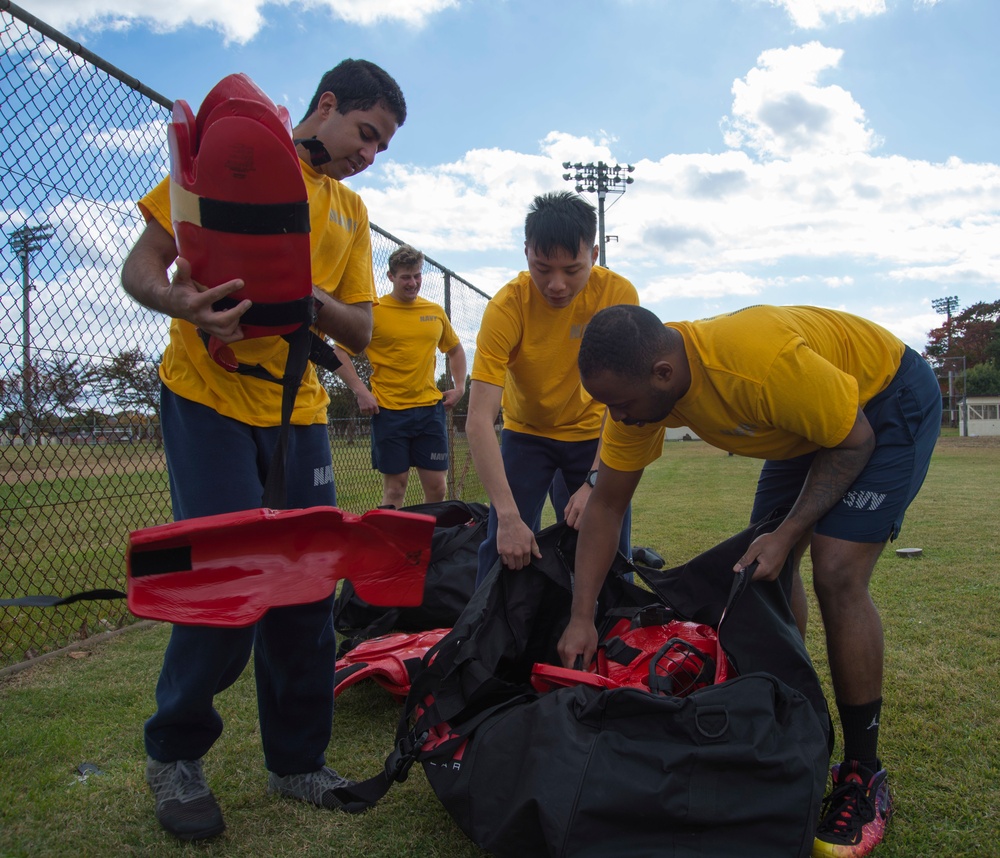 Sailors clean up after an Auxiliary Security Forces training exercise