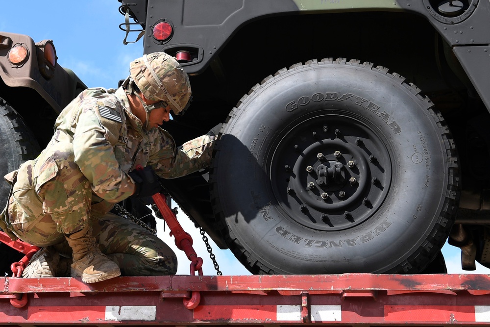 Soldier removes Humvee from trailer