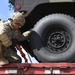 Soldier removes Humvee from trailer