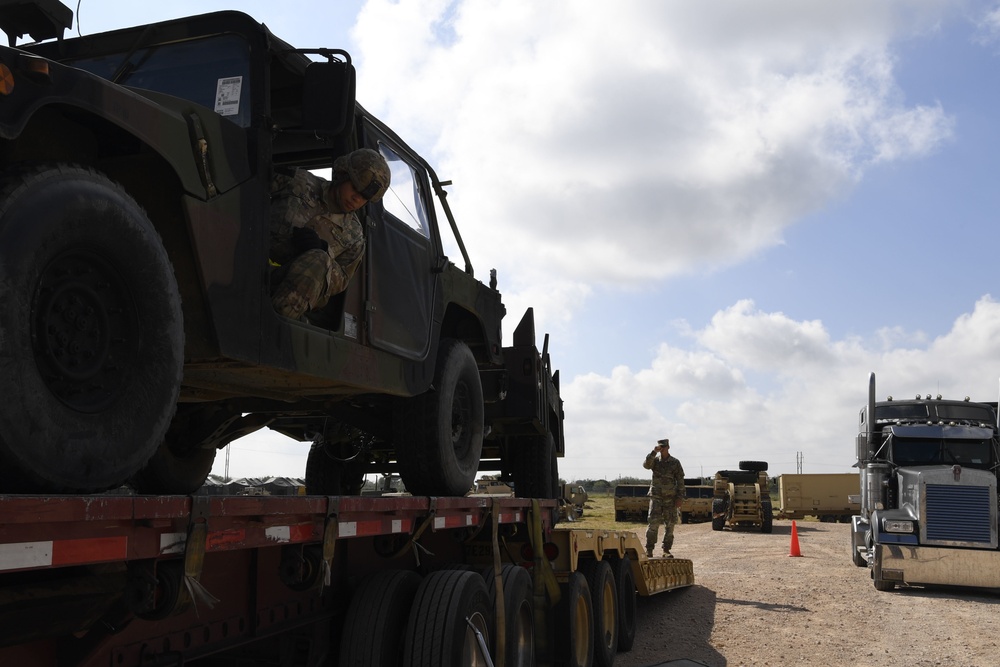 Soldier removes Humvee from trailer