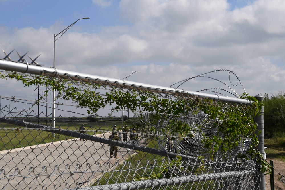 Soldiers install concertina wire