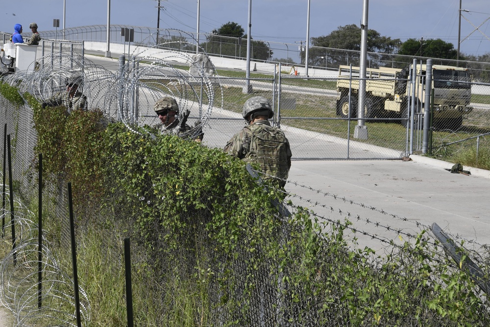 Soldiers install concertina wire