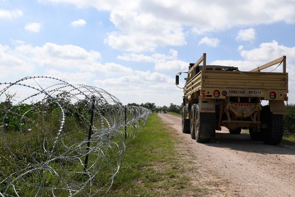 Soldiers install concertina wire