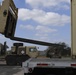 Soldiers remove shipping containers from truck