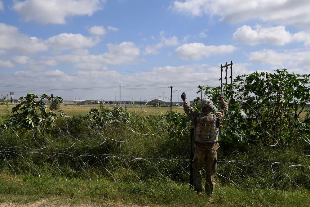 Soldier installs concertina wire