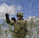 Soldier installs concertina wire