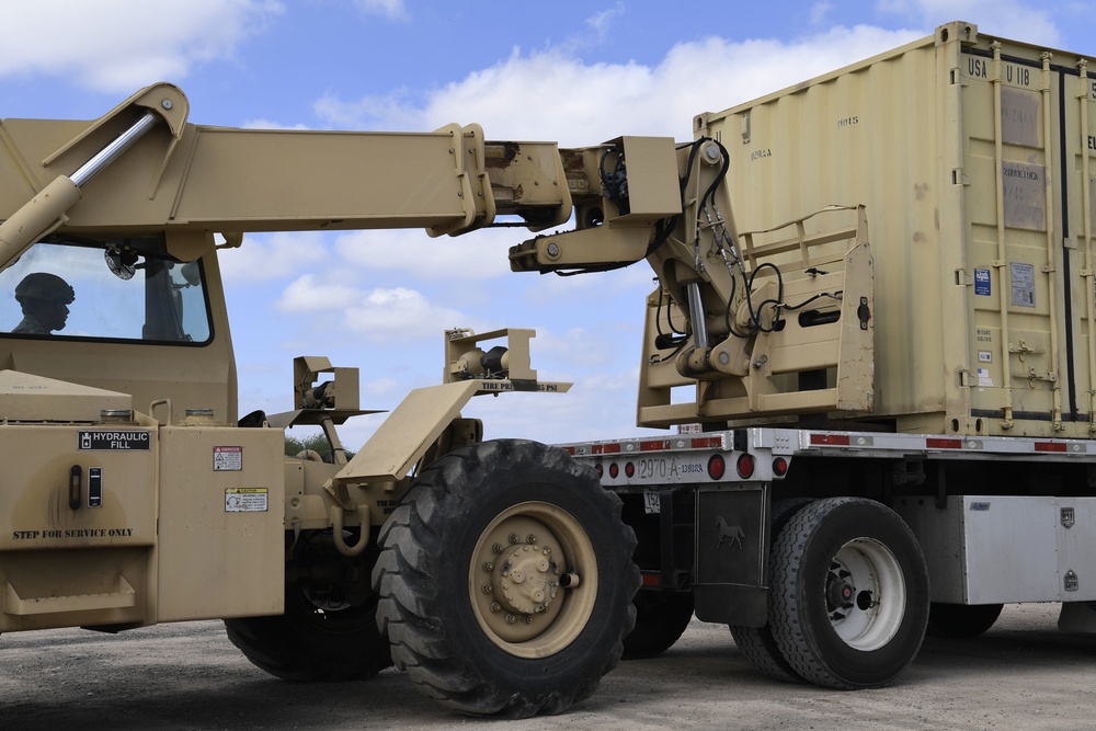 Soldiers move supply containers