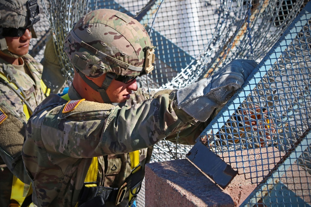 104th Engineer Construction Company install concertina wire in