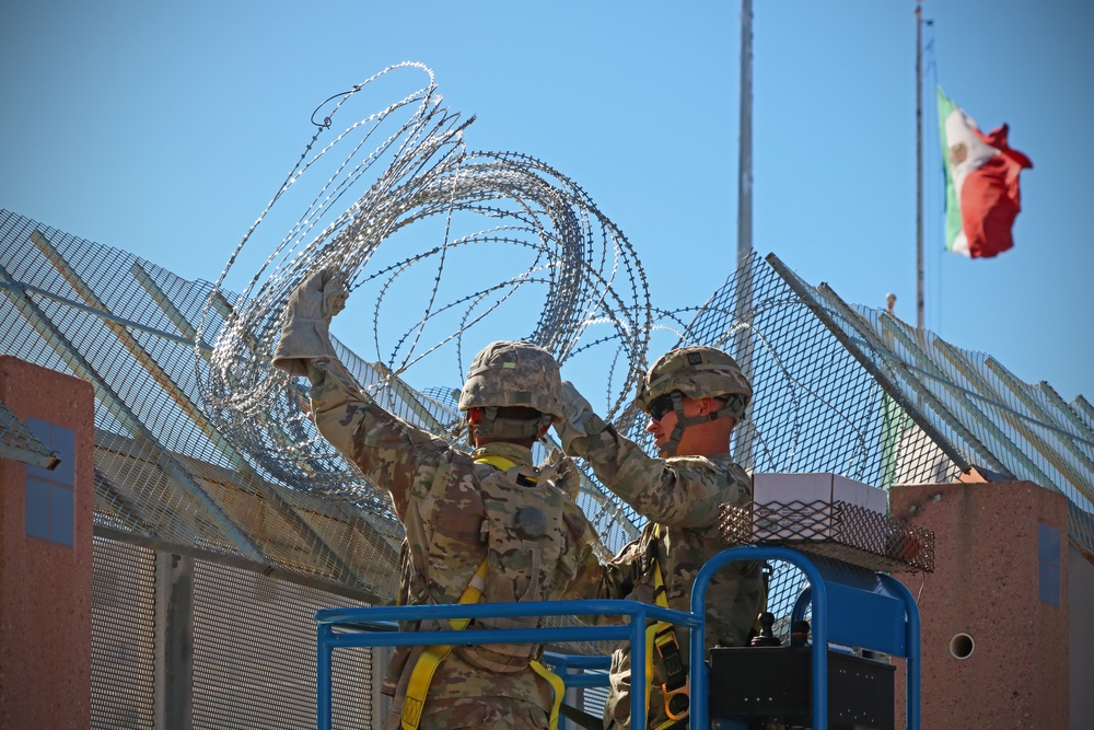 104th Engineer Construction Company install concertina wire