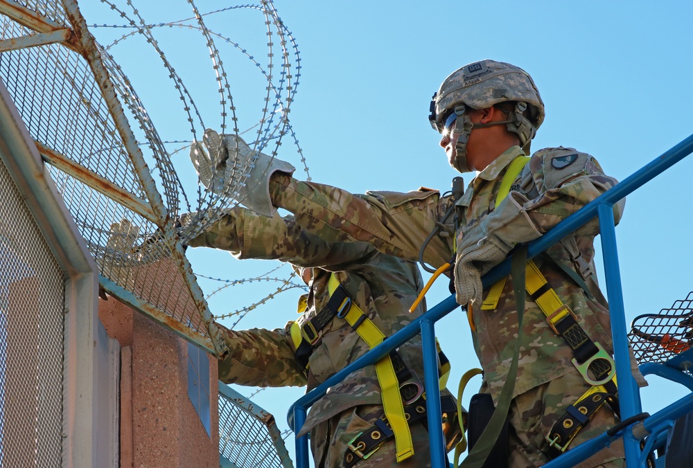 104th Engineer Construction Company install concertina wire