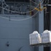 Cargo from the dry cargo and ammunition ship USNS Charles Drew (T-AKE 10) makes its way towards the Nimitz-class aircraft carrier USS John C. Stennis (CVN 74) via a skid.