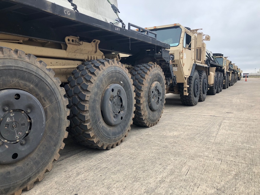 Army Trucks Carry Barriers To Southern Texas