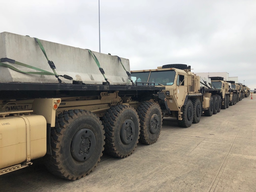 Army Trucks Carry Barriers To Southern Texas