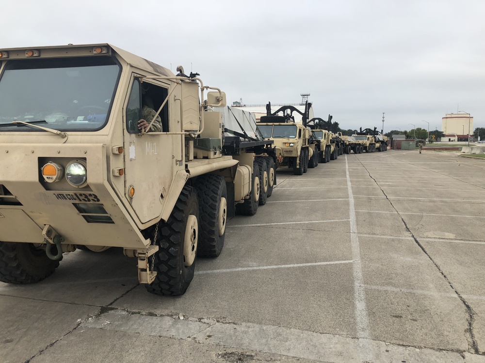 Army Trucks Carry Barriers To Southern Texas