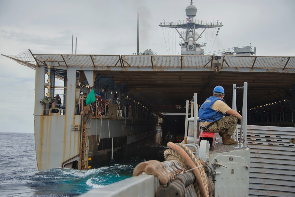 Military Transports Heavy Equipment Vehicles from the USS Ashland to Saipan in Response to Super Typhoon Yutu