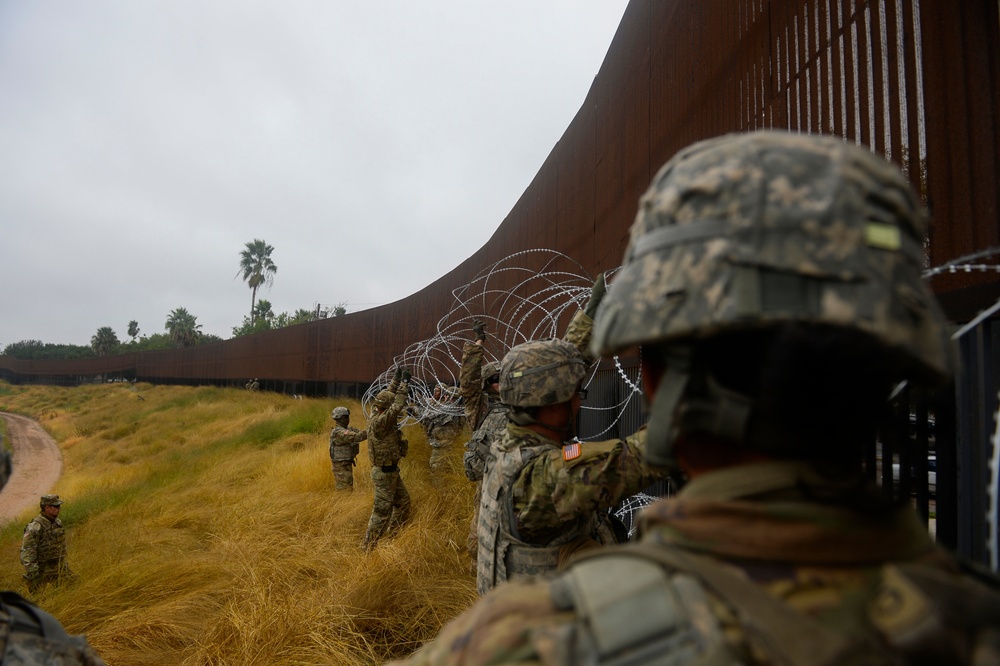 Soldiers Lay Barbed Wire At Gateway International Bridge