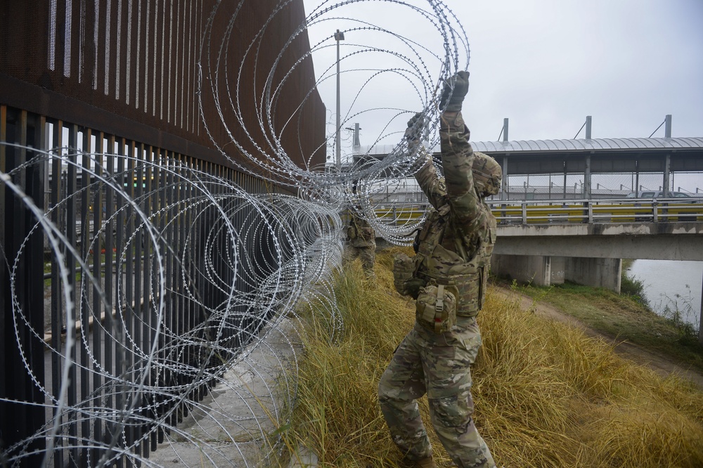 Soldiers Lay Barbed Wire At Gateway International Bridge