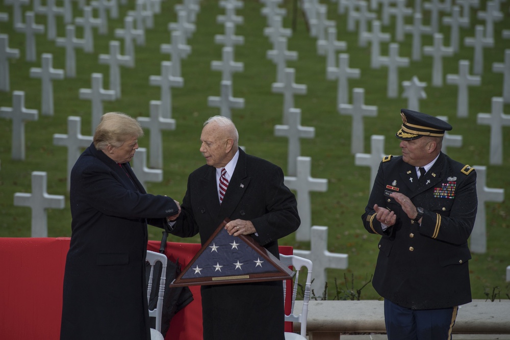 President Donald J. Trump presents an American flag to Secretary of the American Battle Monuments Commission, retired Maj. Gen. William M. Matz, at the Suresnes American Cemetery while honoring the centennial of Armistice Day, Paris, France.