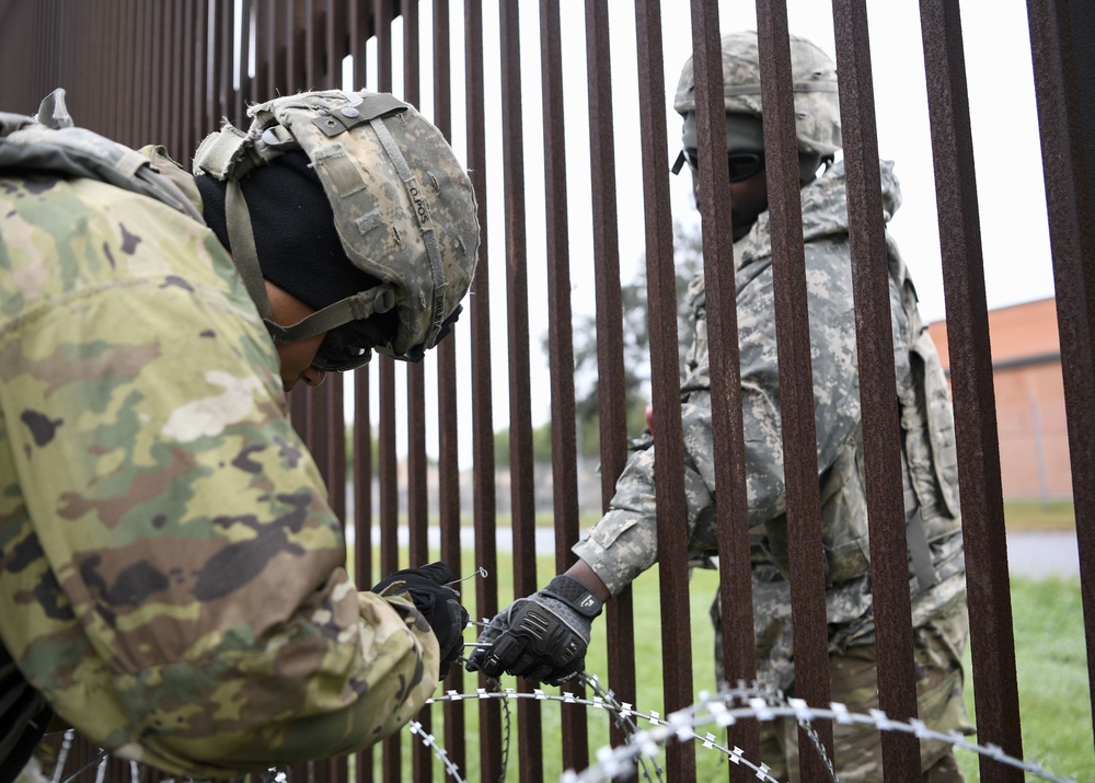 Army Engineers Secure Concertina Wire Together