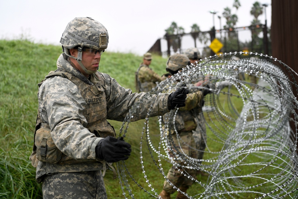 An Army Engineer Stacks Concertina Wiring
