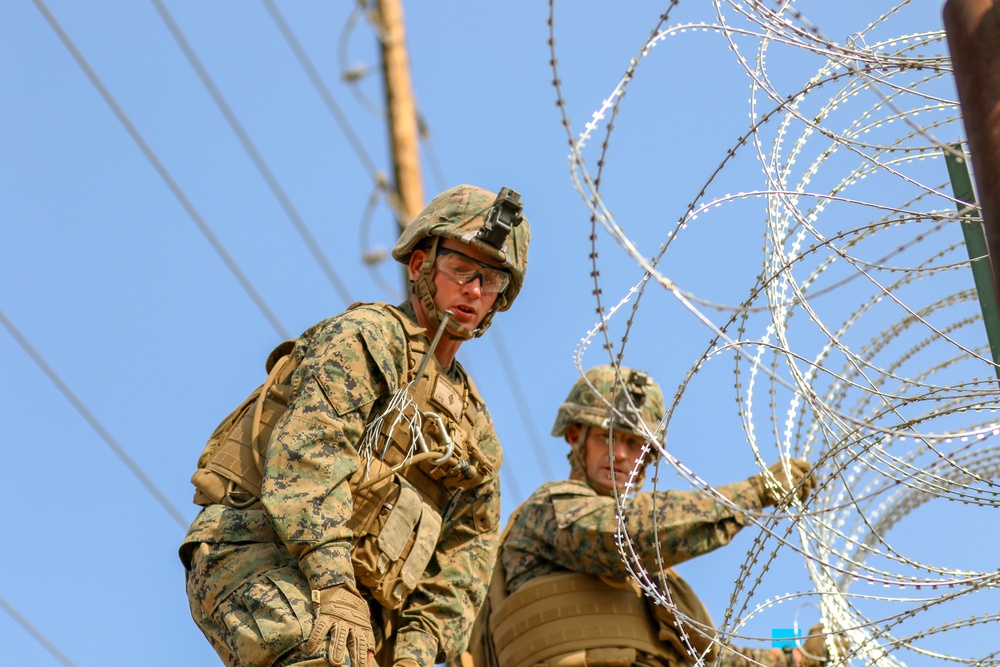 Col. Kyle Ellison Lays Concertina Wire on Border Fencing