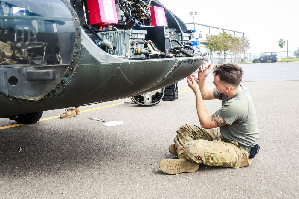 82nd CAB UH-60 Blackhawk Helicopter Repairer Tightens Bolts