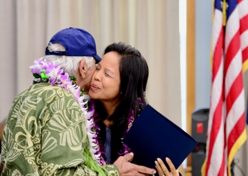 Leah Belmonte presents Mitchell Lani a certificate on behalf of Gov. David Ige