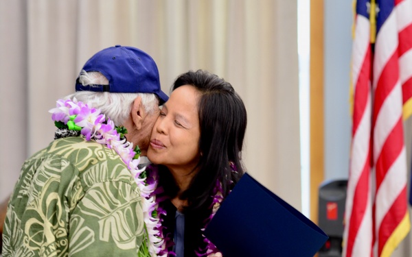 Leah Belmonte presents Mitchell Lani a certificate on behalf of Gov. David Ige