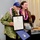 Rebecca Crall presents a certificate on behalf of Rep. Lynn DeCoite