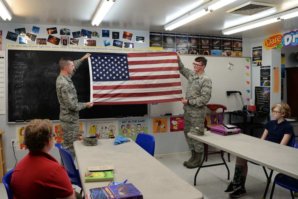 Airmen teach students proper flag procedures