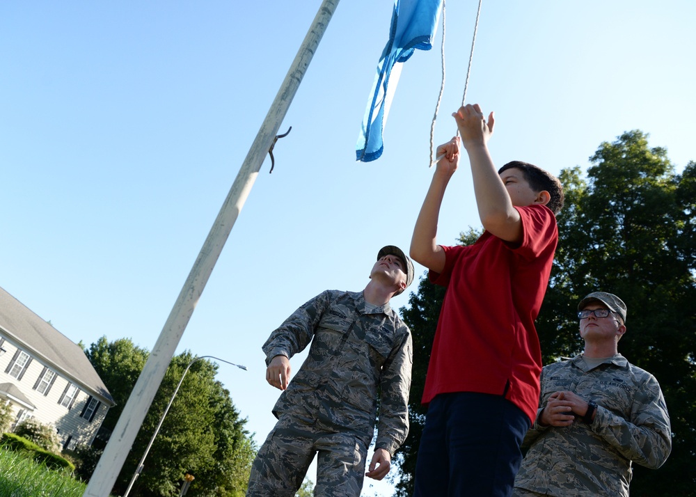 Airmen teach students proper flag procadures