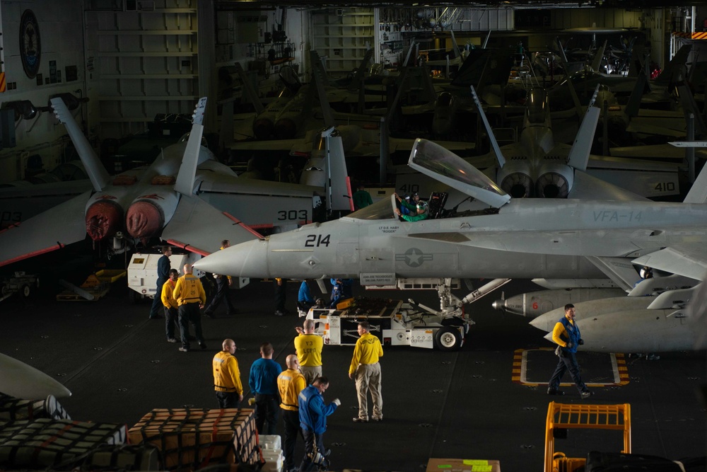 Sailors prepare to taxi aircraft in the hangar bay aboard the Nimitz-class aircraft carrier USS John C. Stennis (CVN 74).