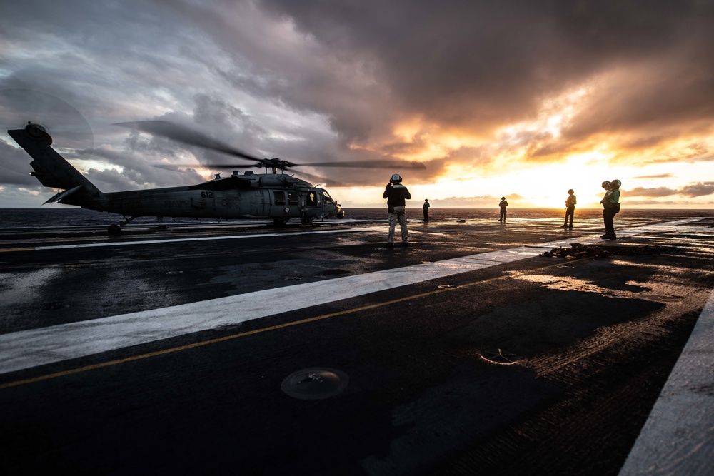 Sailors standby during an engine test on an MH-60S Knight Hawk