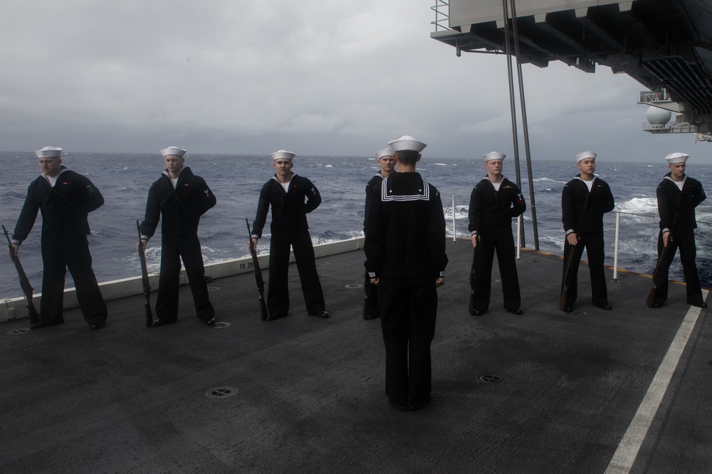 Sailors stand by before firing a rifle volley during a burial-at-sea