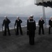 Sailors stand by before firing a rifle volley during a burial-at-sea