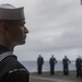 Legalman 1st Class Joshua Boga, from Dayton, Nevada, waits for the call to attention during a burial-at-sea aboard the Nimitz-class aircraft carrier USS John C. Stennis (CVN 74).