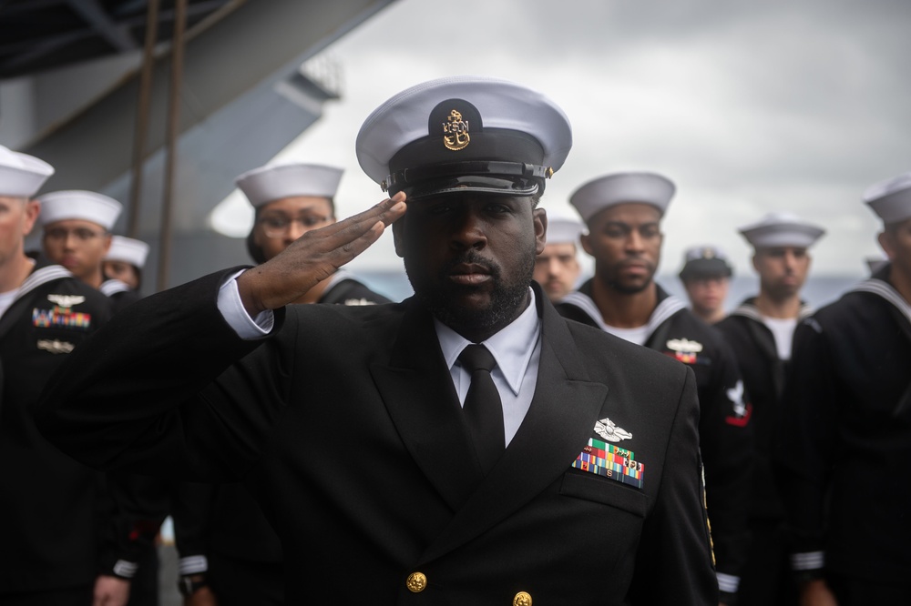 Chief Religious Program Specialist John Dillard, from Montgomery, Alabama salutes during a burial-at-sea aboard the Nimitz-class aircraft carrier USS John C. Stennis (CVN 74).