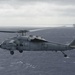 An MH-60S Knight Hawk, with Helicopter Sea Combat Squadron (HSC) 14, flies toward the Nimitz-class aircraft carrier USS John C. Stennis (CVN 74).