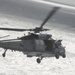 An MH-60S Knight Hawk, with Helicopter Sea Combat Squadron (HSC) 14, flies towards the Nimitz-class aircraft carrier USS John C. Stennis (CVN 74).