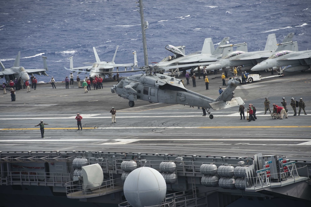 An MH-60S Knight Hawk, with Helicopter Sea Combat Squadron (HSC) 14, approaches the flight deck of the Nimitz-class aircraft carrier USS John C. Stennis (CVN 74).