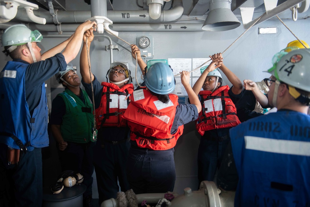 Sailors secure a line during a refueling-at-sea aboard the Nimitz-class aircraft carrier USS John C. Stennis (CVN 74).
