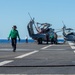 Sailors transit the flight deck before flight quarters aboard the Nimitz-class aircraft carrier USS John C. Stennis (CVN 74).