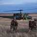 Members of the 341st Security Forces Group prepare to load a helicopter assigned to the 40th Helicopter Squadron during a launch facility recapture exercise during Global Thunder 19, Oct. 30, 2018