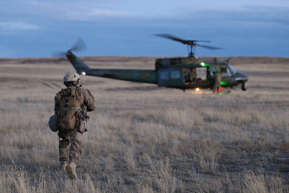 A member of the 341st Security Forces Group prepares to load a helicopter assigned to the 40th Helicopter Squadron during a launch facility recapture exercise during Global Thunder 19, Oct. 30, 2018, at Malmstrom Air Force Base, Mont.