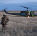 A member of the 341st Security Forces Group prepares to load a helicopter assigned to the 40th Helicopter Squadron during a launch facility recapture exercise during Global Thunder 19, Oct. 30, 2018, at Malmstrom Air Force Base, Mont.