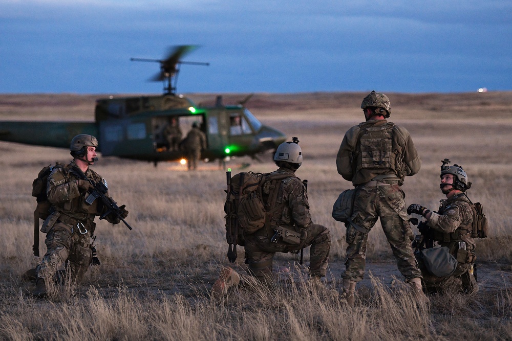 Members of the 341st Security Forces Group prepare to load a helicopter assigned to the 40th Helicopter Squadron during a launch facility recapture exercise during Global Thunder 19, Oct. 30, 2018, at Malmstrom Air Force Base, Mont.