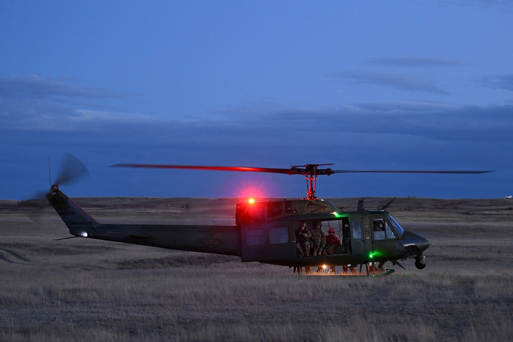 Members of the 341st Security Forces Group prepare to load a helicopter assigned to the 40th Helicopter Squadron during a launch facility recapture exercise during Global Thunder 19, Oct. 30, 2018, at Malmstrom Air Force Base, Mont.