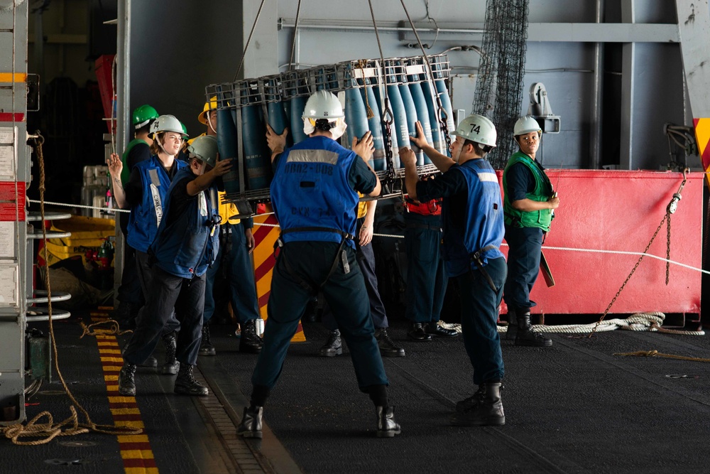 Boatswain's Mate 3rd Class Tanesha Brown directs Sailors during a replenishment-at-sea evolution aboard the Nimitz-class aircraft carrier USS John C. Stennis (CVN 74).